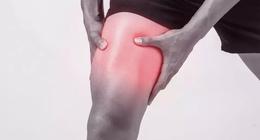 Person with muscle pain in the leg, thigh area highlighted in red