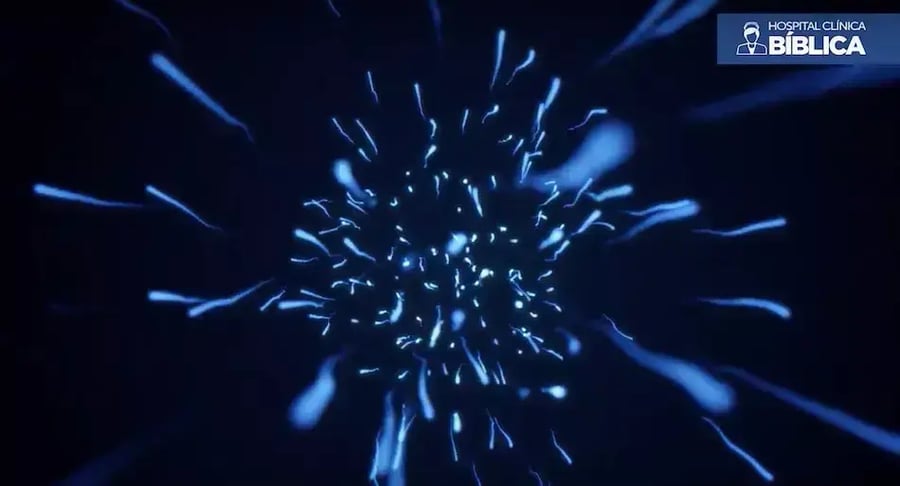 Digital illustration of moving spermatozoa on dark blue background.