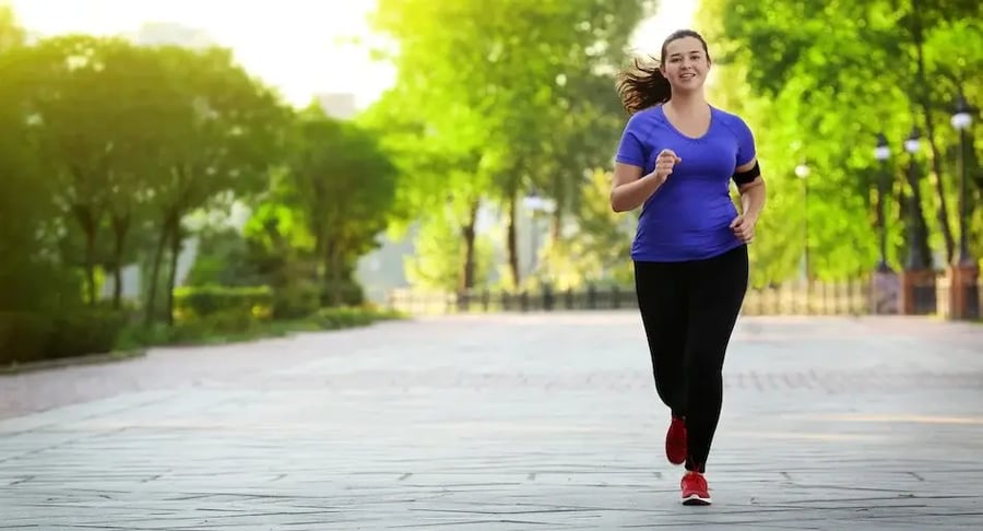 Young woman exercising while jogging in an open-air park