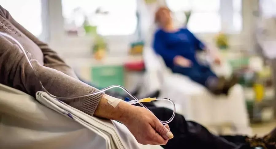 Patient receiving chemotherapy treatment with intravenous serum in the clinic